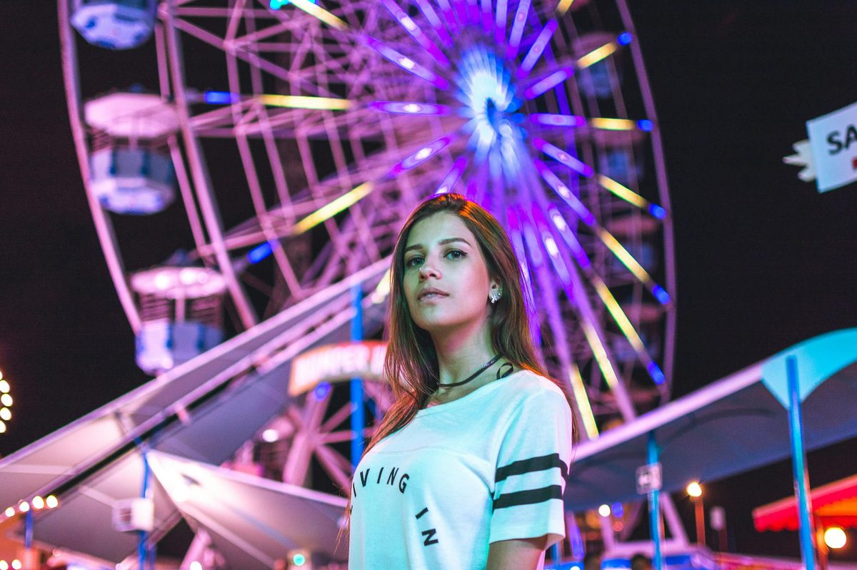 Neon ferris wheel at a night-time funfair